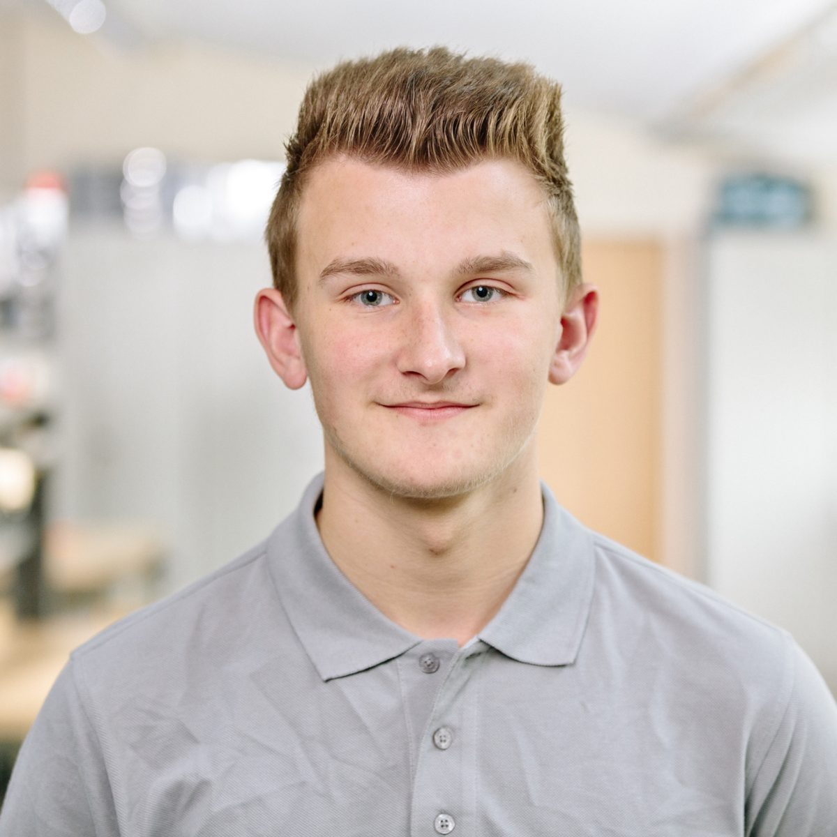 Portrait of an apprentice in work clothes of the company Koenig und Bauer AG