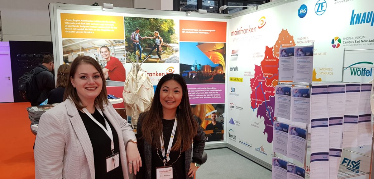 Two employees of Region Mainfranken GmbH at their own exhibition stand in Lower Franconia