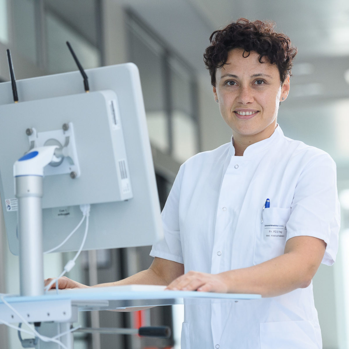 Portrait of the Head of Intensive Care Medicine at Würzburg University Hospital in white work clothes 