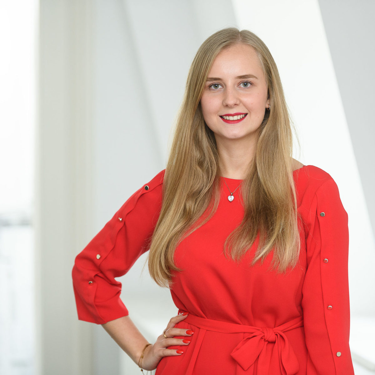 Portrait of a female employee in red dress at Würzburg University Hospital