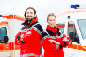 Emergency doctor and nurse standing in front of ambulance